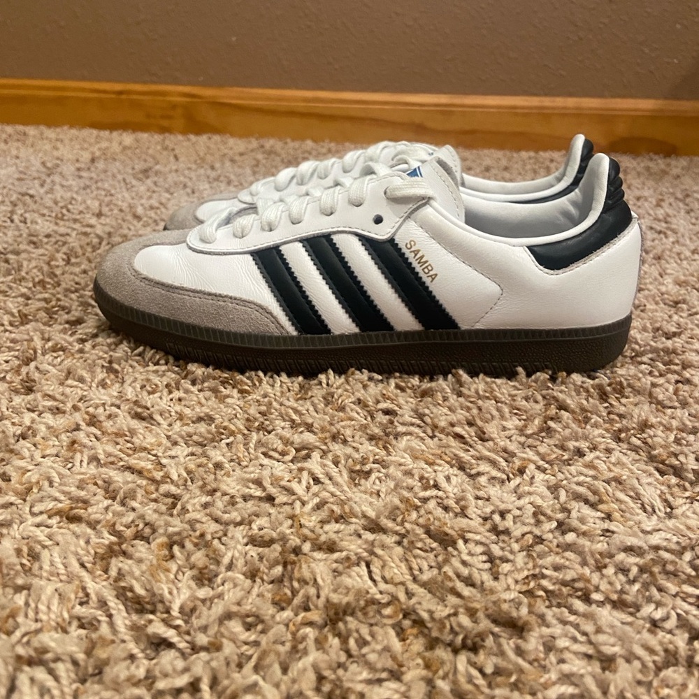 White and black adidas sambas.